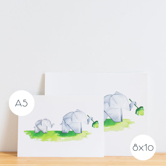 Watercolour painting art print. The watercolour illustration shows two painted origami elephants on green grass with one holding a monstera plant leaf.