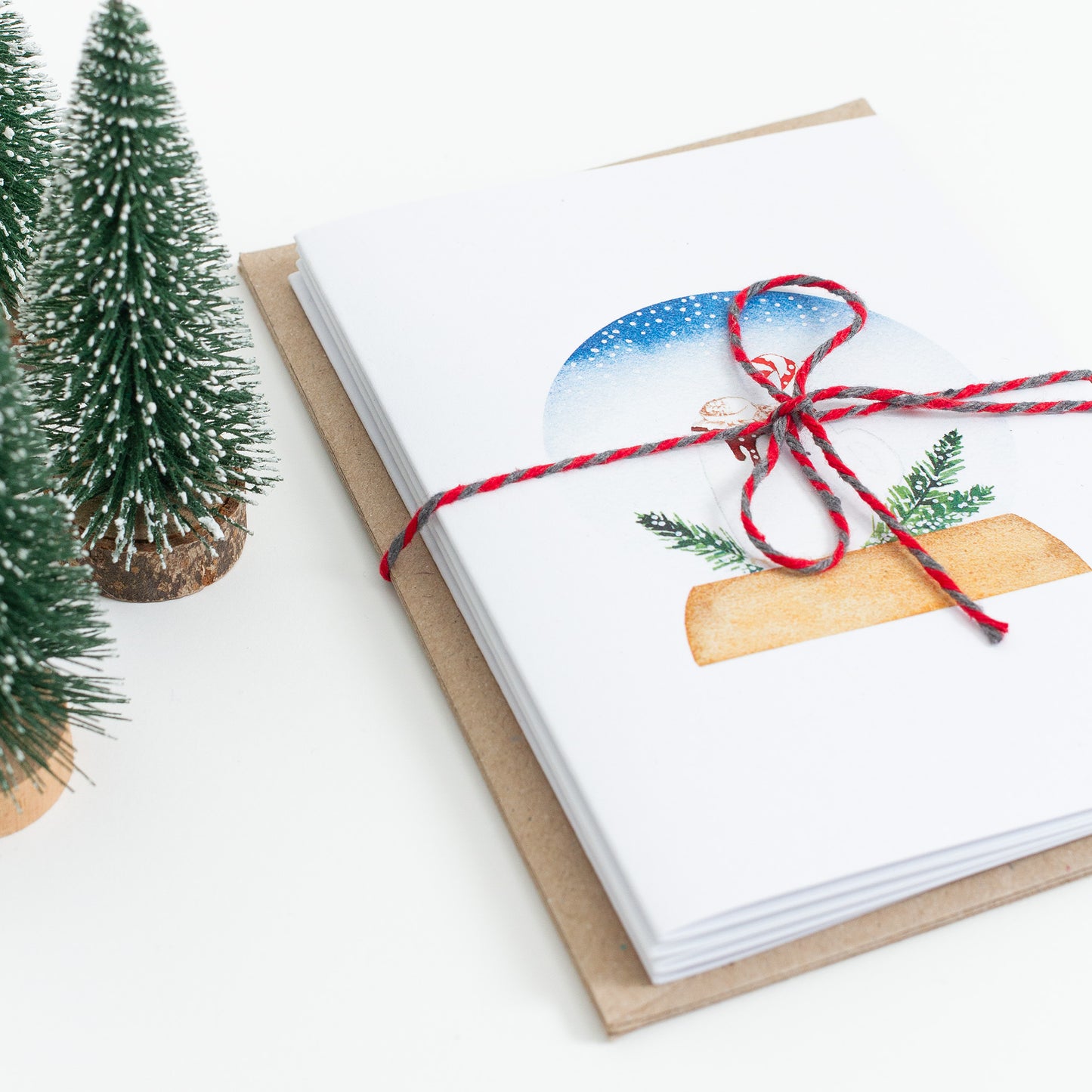 Series of festive food Snow Globe cards designed from handmade watercolour paintings. Available as a set of 4 or a set of 8 cards. The illustrations are: hot chocolate, mince pies, Christmas pudding, yule log.
