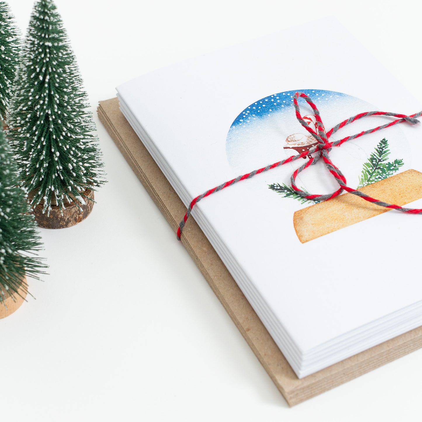 Series of festive food Snow Globe cards designed from handmade watercolour paintings. Available as a set of 4 or a set of 8 cards. The illustrations are: hot chocolate, mince pies, Christmas pudding, yule log.