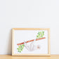 Watercolour painting art print. The watercolour illustration shows an origami sloth hanging from a tree branch with leaves.