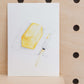 The art print is an illustration showing a block of butter with a piece taken out with a butter knife on the side. Created from handmade watercolour painting.