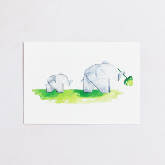 Watercolour painting art print. The watercolour illustration shows two painted origami elephants on green grass with one holding a monstera plant leaf.