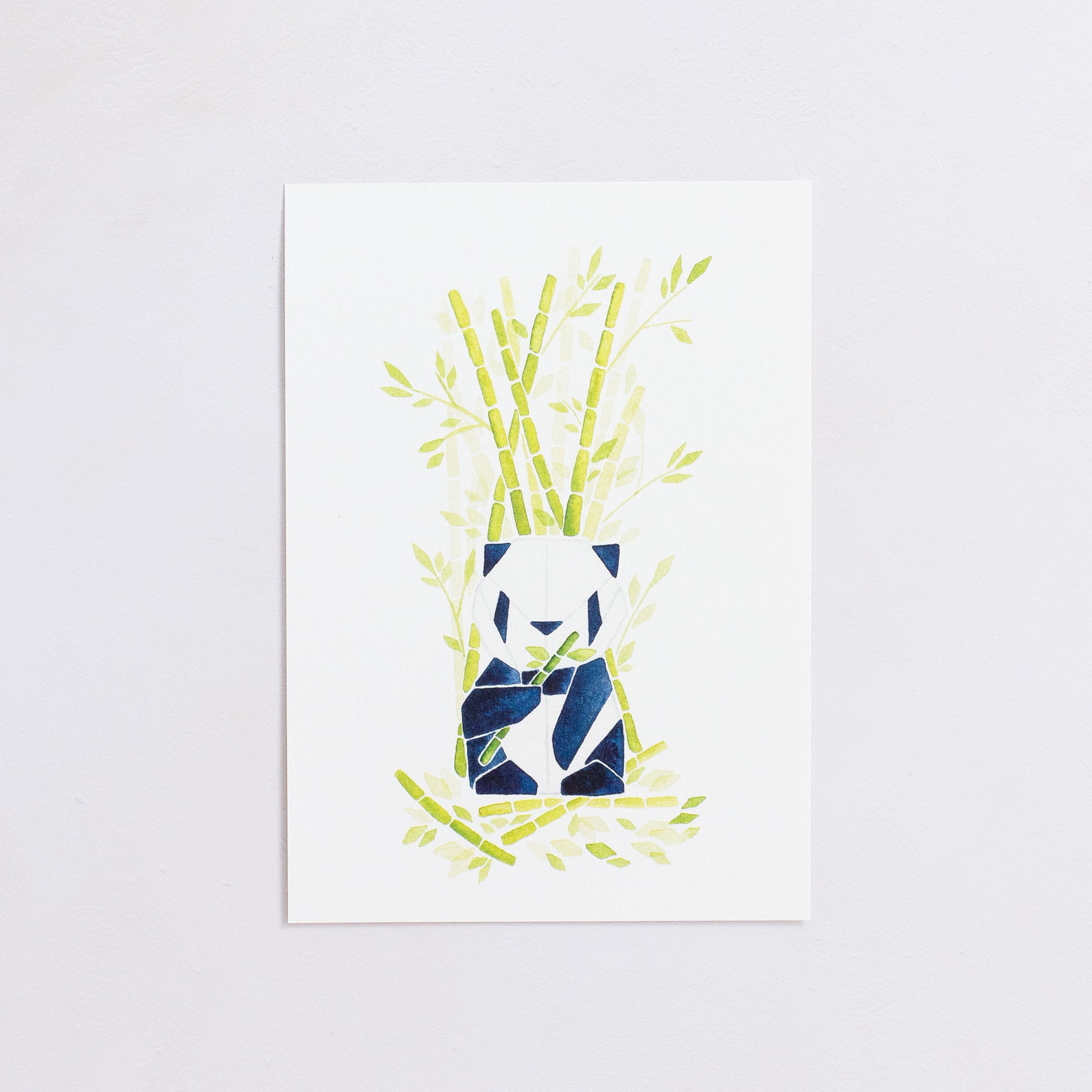 Watercolour painting art print. The watercolour illustration shows an origami panda sitting among bamboo trees, branches and leaves.